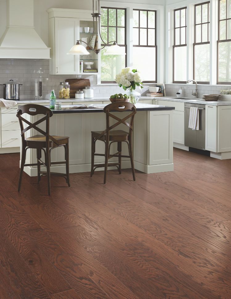 kitchen remodel with wood floors, island countertops, and white cabinets