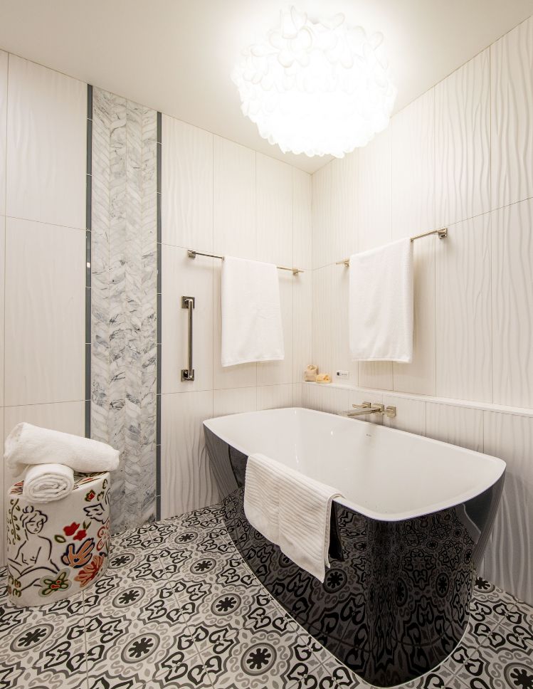 bath design with tile floors and tub