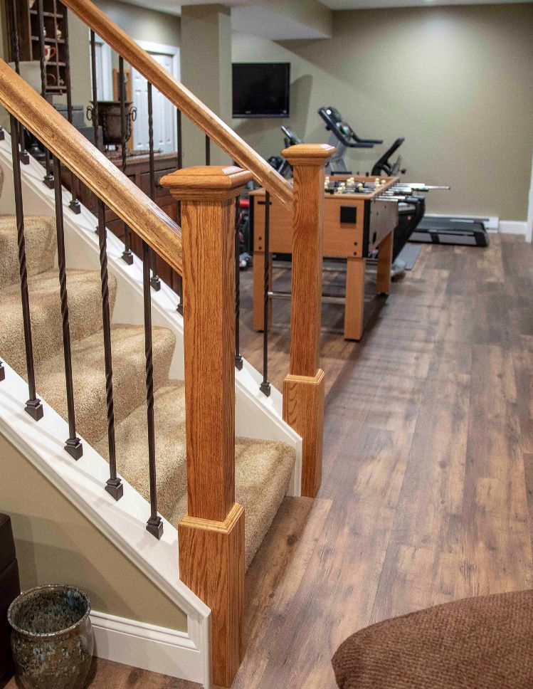 finished basement with LVP floors and carpeted stairs